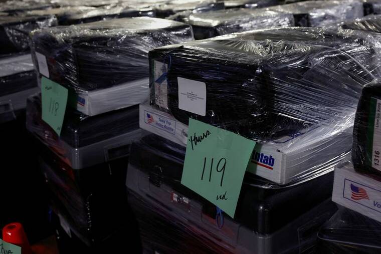 REUTERS/SHANNON STAPLETON/FILE PHOTO
                                Wrapped voting machines wait for delivery inside the Allegheny County Elections Warehouse in Pittsburgh, Penn., on Wednesday.